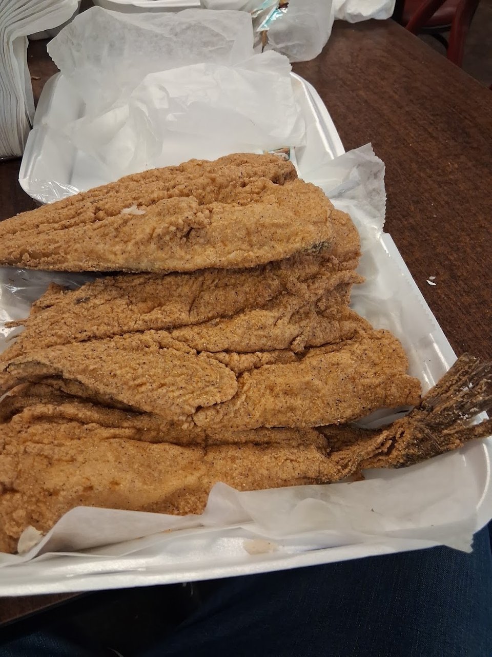 Printed menu with catfish and wings.